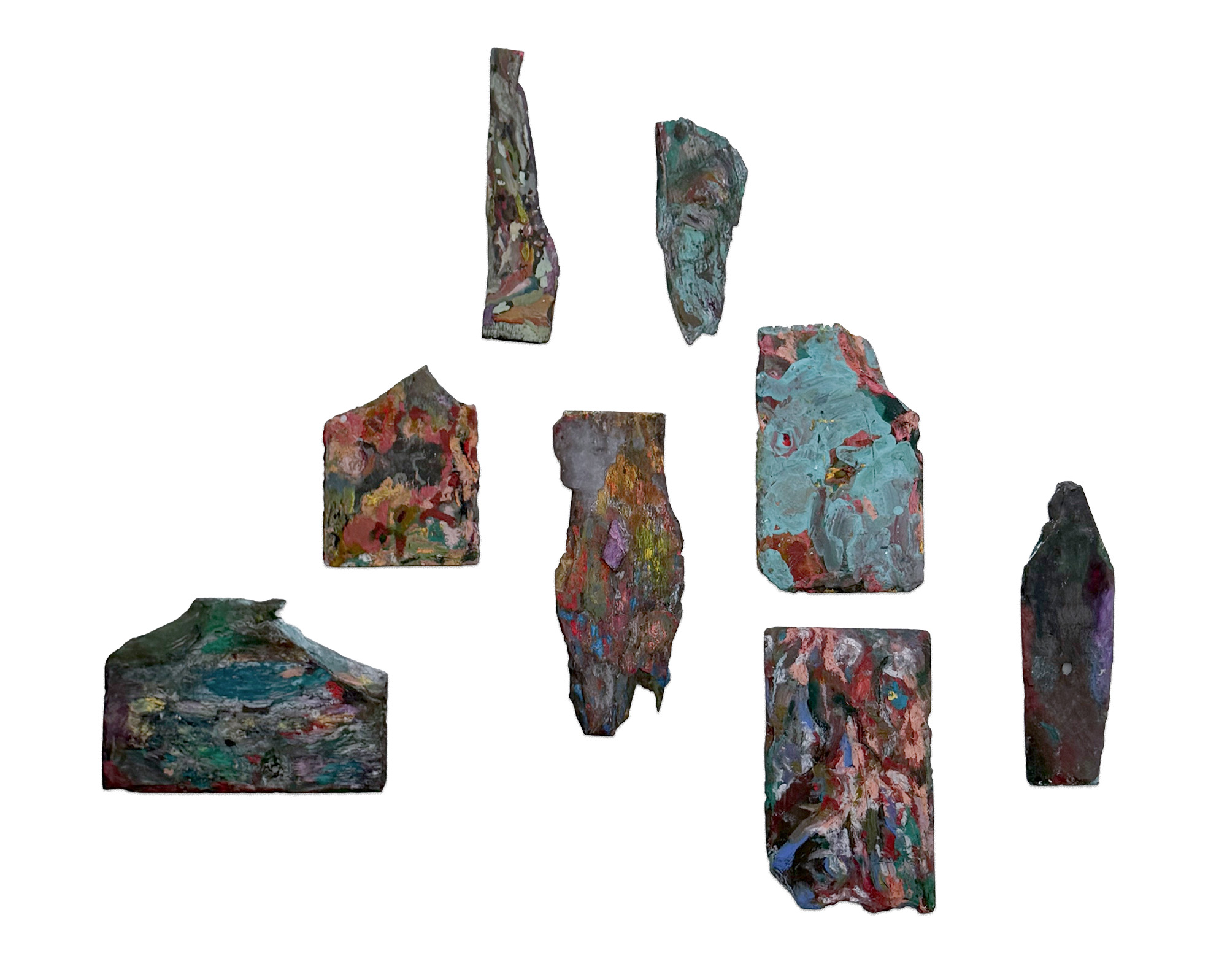 Multiple painted slate works arranged together as an installation